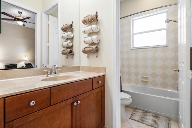 bathroom with toilet, ceiling fan, tile patterned flooring, vanity, and washtub / shower combination