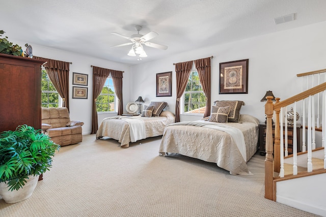 bedroom featuring carpet floors, visible vents, and ceiling fan