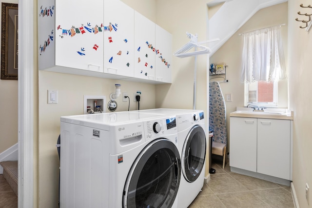 clothes washing area featuring light tile patterned flooring, a sink, cabinet space, and washer and dryer