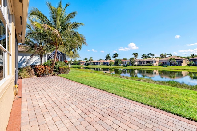 view of community featuring a lawn, a water view, and a residential view