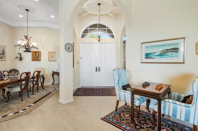 foyer entrance featuring light tile patterned floors, baseboards, a high ceiling, a chandelier, and recessed lighting