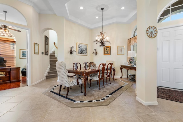 dining area with arched walkways, plenty of natural light, baseboards, and light tile patterned floors