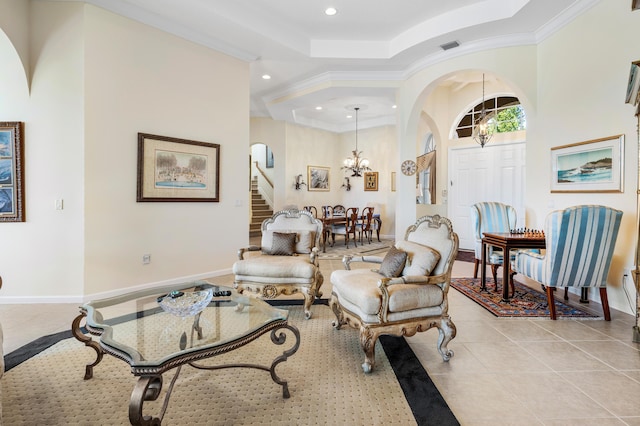 living room with arched walkways, a notable chandelier, light tile patterned floors, a raised ceiling, and stairway