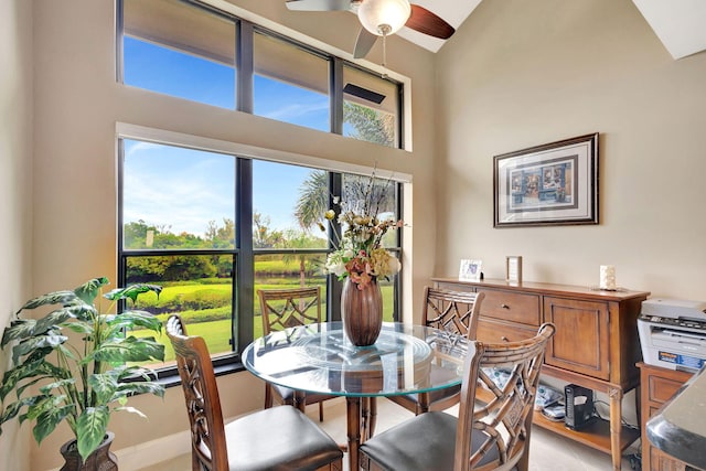 dining room featuring high vaulted ceiling and a ceiling fan