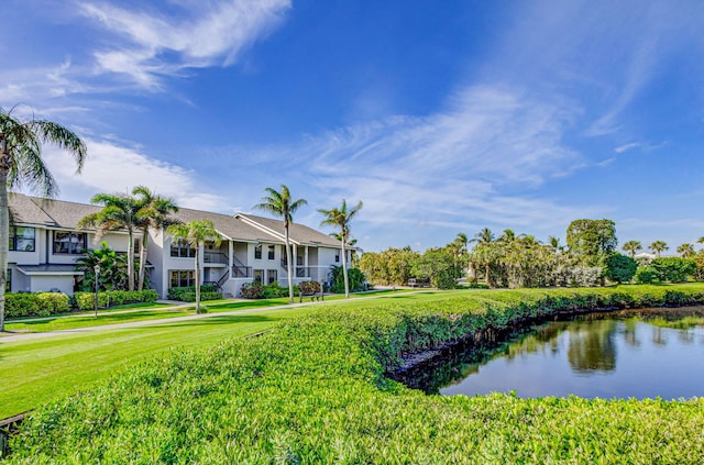 exterior space with a water view and a lawn