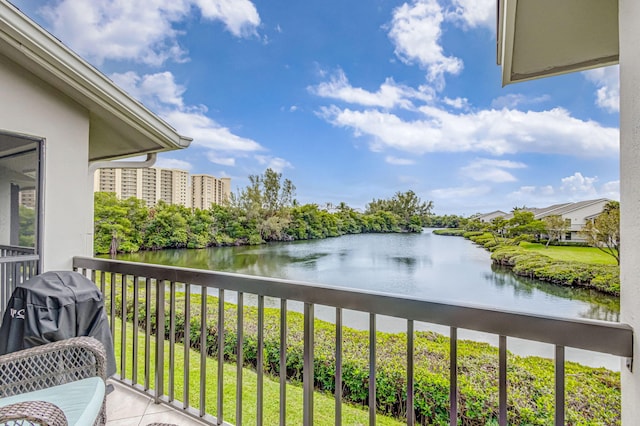 balcony with a water view and grilling area