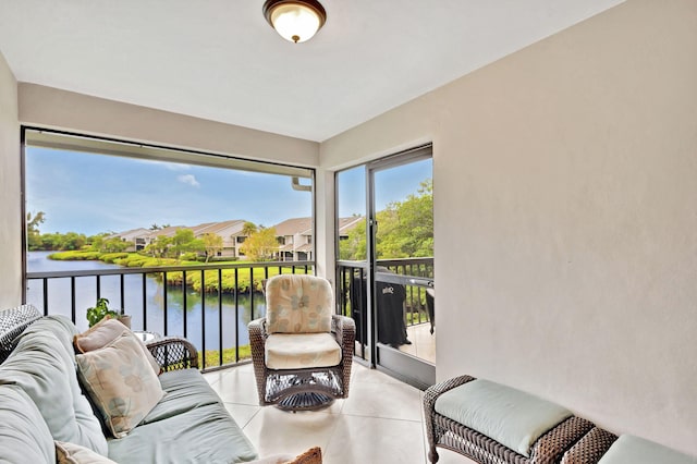 sunroom with a residential view and a water view