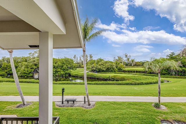 view of property's community featuring view of golf course, a water view, and a yard