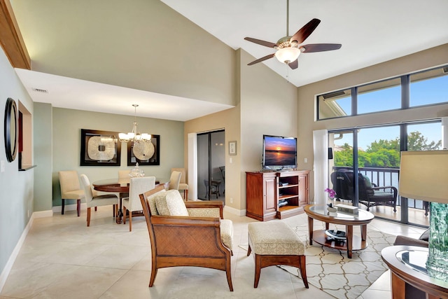 living area with light tile patterned floors, baseboards, visible vents, high vaulted ceiling, and ceiling fan with notable chandelier