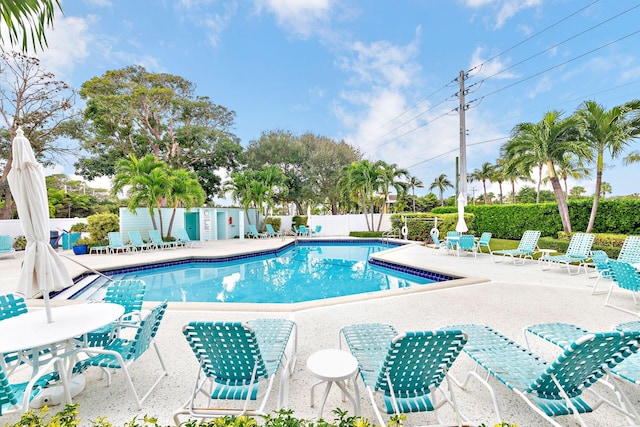 pool featuring fence and a patio