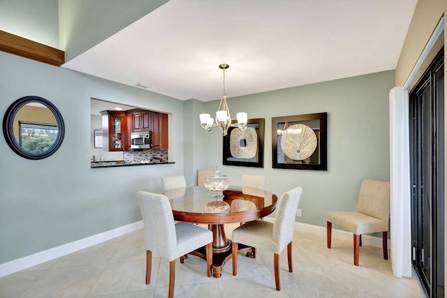 dining space featuring a chandelier, visible vents, baseboards, and light tile patterned flooring