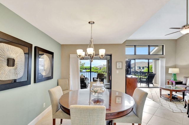 dining space featuring light tile patterned floors, baseboards, and ceiling fan with notable chandelier