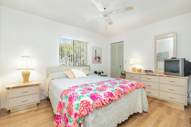 bedroom featuring a closet, ceiling fan, and light wood-type flooring