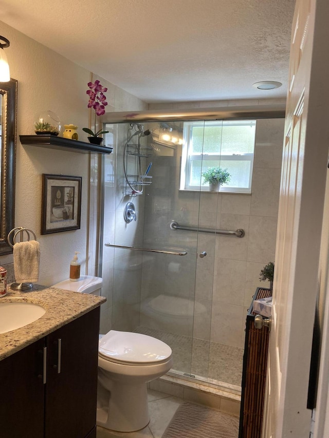 bathroom featuring radiator, vanity, an enclosed shower, a textured ceiling, and toilet