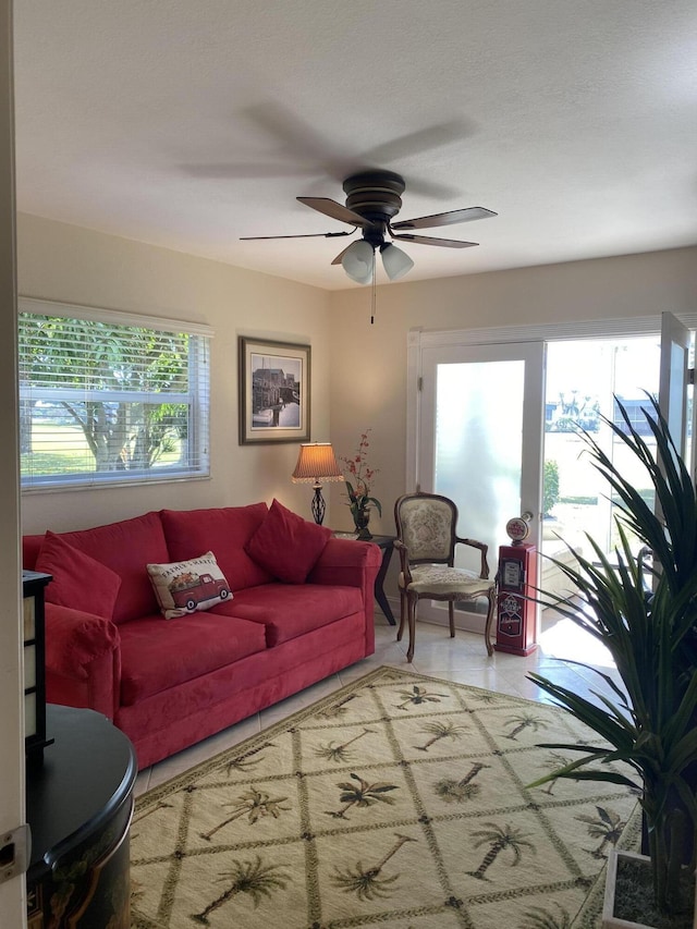 living room with tile patterned flooring and ceiling fan