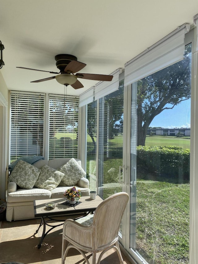 sunroom / solarium featuring ceiling fan