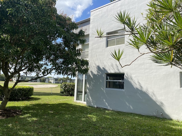 view of side of home featuring a lawn