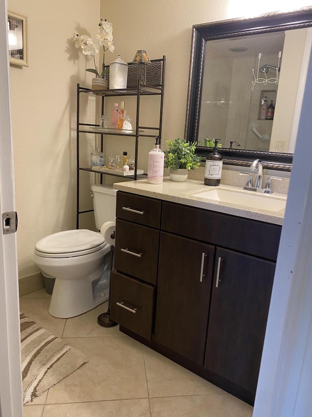 bathroom with vanity, tile patterned floors, and toilet