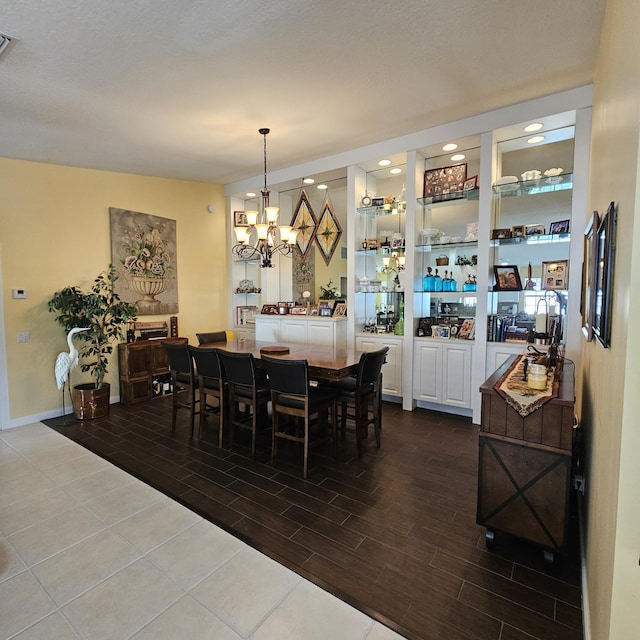 dining space featuring a chandelier, visible vents, and wood tiled floor