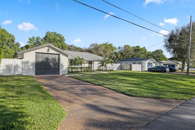 ranch-style home featuring stucco siding, an attached garage, fence, driveway, and a front lawn