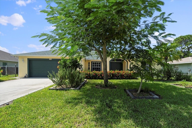 view of front of home with a garage and a front yard