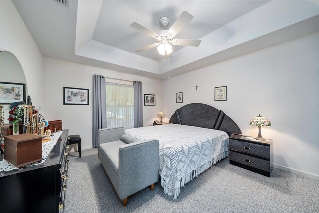 324 NE Gladiola Ave, Port Saint Lucie, FL 34983 - carpeted bedroom with a raised ceiling and ceiling fan