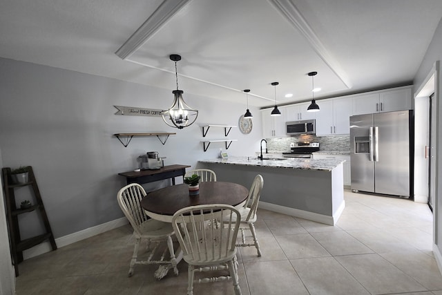 dining area featuring light tile patterned flooring, sink, and a notable chandelier