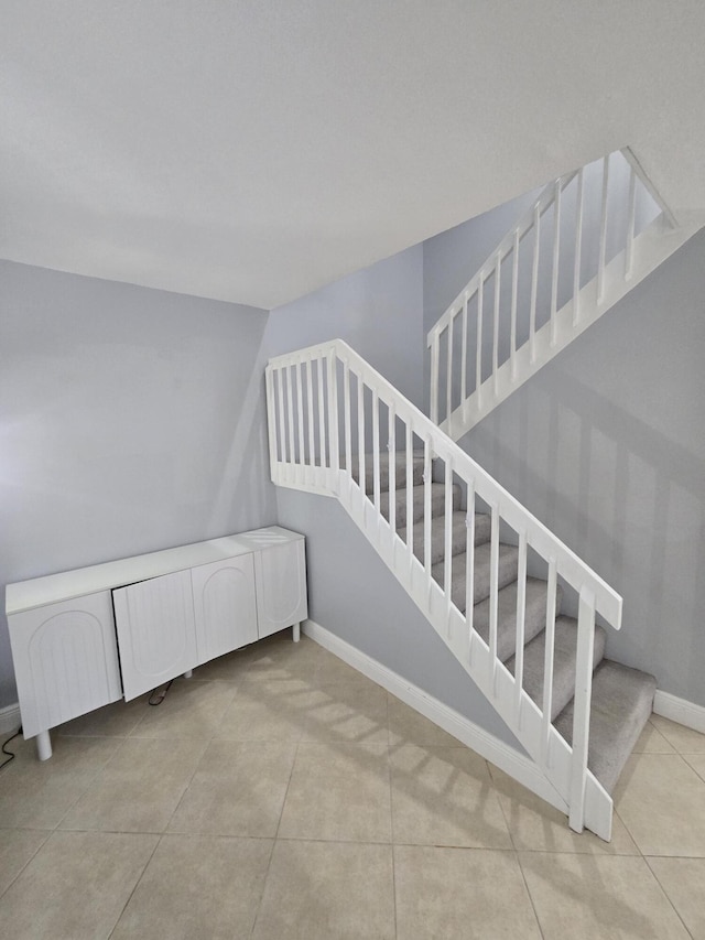 stairway with tile patterned flooring