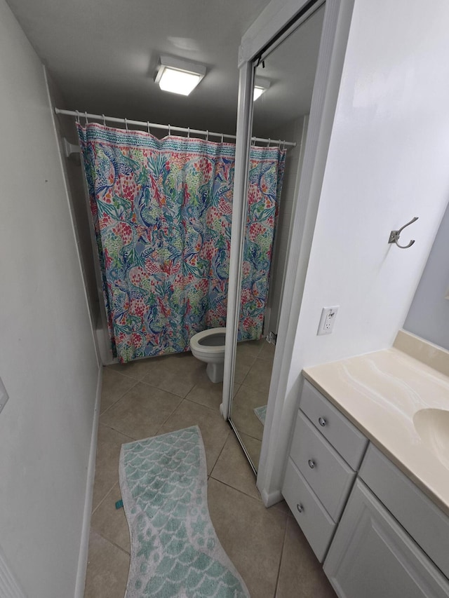 bathroom with vanity, toilet, and tile patterned floors