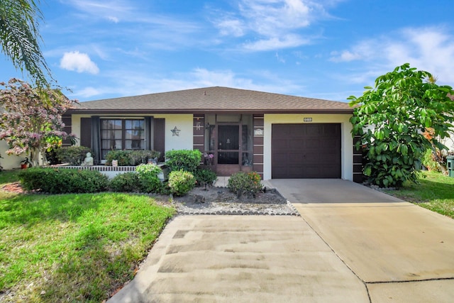 view of front facade featuring a garage and a front lawn