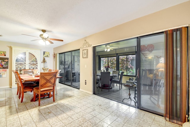 dining space featuring ceiling fan and a textured ceiling