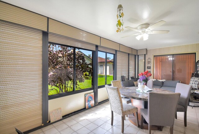 tiled dining room with ceiling fan