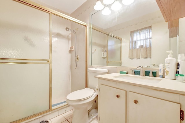 bathroom featuring toilet, vanity, tile patterned floors, and walk in shower