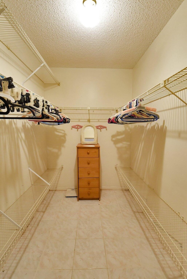 spacious closet with tile patterned flooring