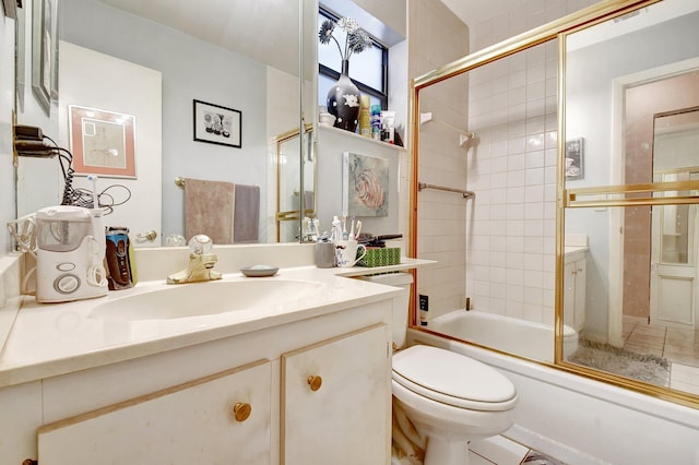 full bathroom with vanity, shower / bath combination with glass door, and toilet