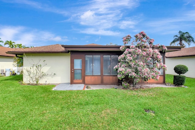 rear view of house with a yard