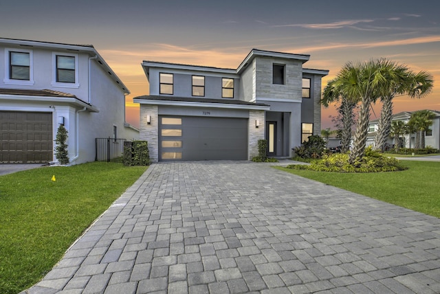 contemporary house with a yard and a garage