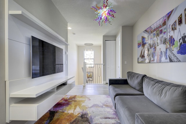 living room with hardwood / wood-style floors and a textured ceiling