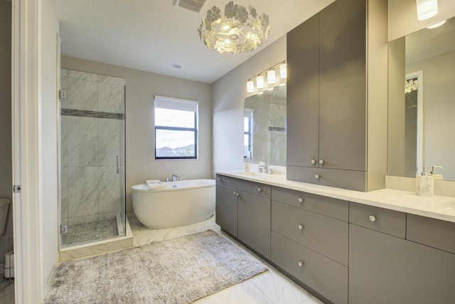 bathroom featuring vanity and shower with separate bathtub