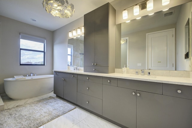 bathroom featuring vanity and a washtub