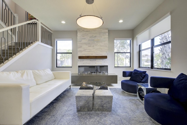 living room with a fireplace and a wealth of natural light