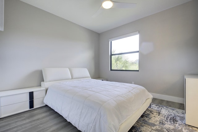 bedroom with ceiling fan and dark hardwood / wood-style flooring