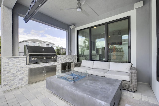 view of patio / terrace with ceiling fan, a grill, and exterior kitchen