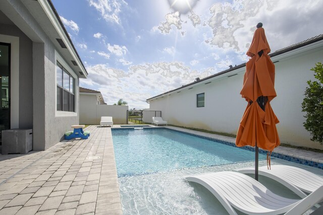 view of pool featuring a patio and an outdoor hot tub