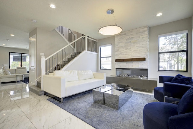 living room with a stone fireplace