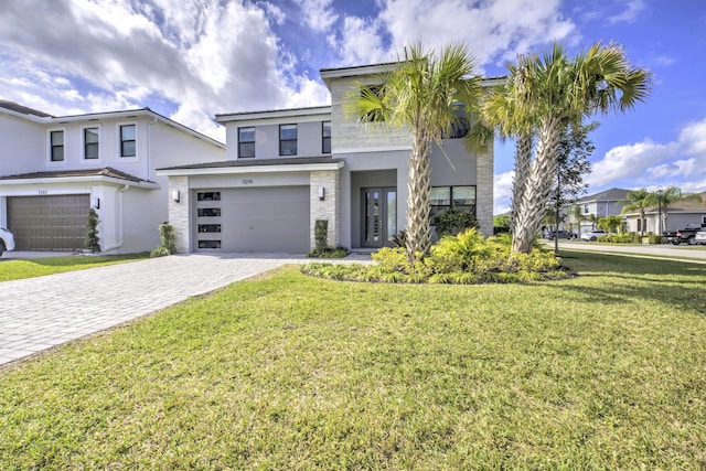 view of front of property with a garage and a front yard