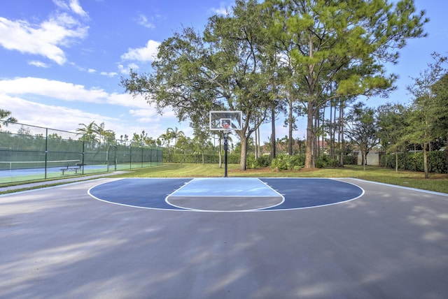 view of sport court with a yard and tennis court