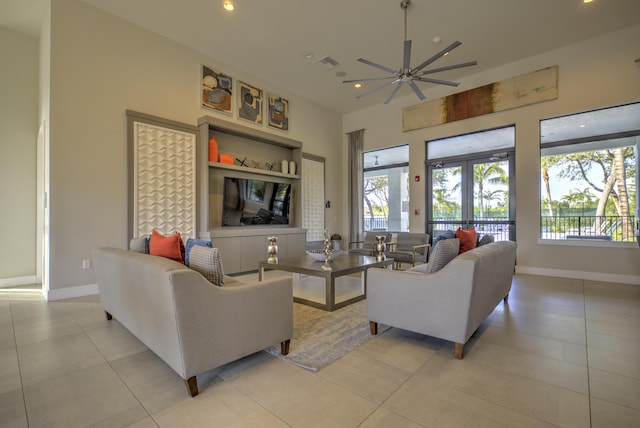 living room featuring light tile patterned floors, a wealth of natural light, french doors, and ceiling fan