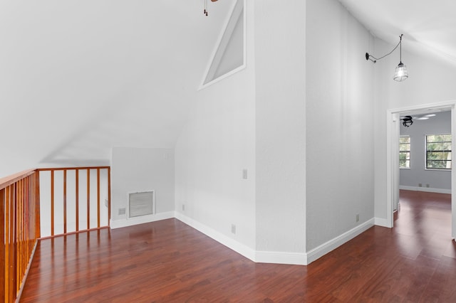 additional living space featuring ceiling fan, high vaulted ceiling, and dark hardwood / wood-style floors