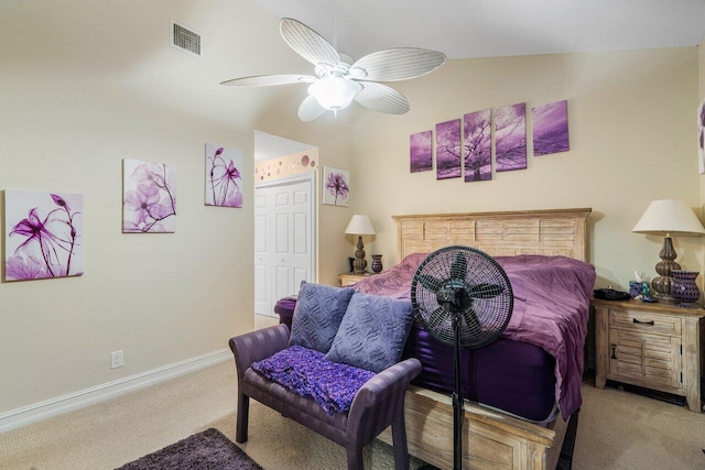 bedroom featuring a closet, vaulted ceiling, light colored carpet, and ceiling fan